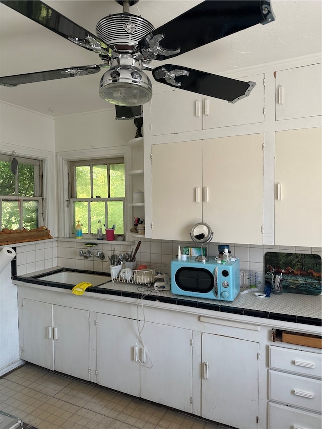 kitchen with sink, decorative backsplash, and white cabinetry