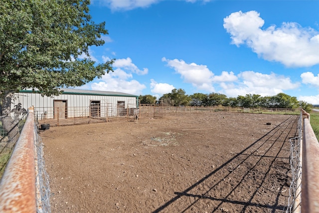 view of yard with an outdoor structure and a rural view