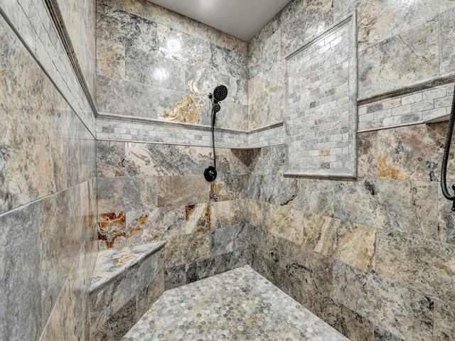 interior details with a tile shower