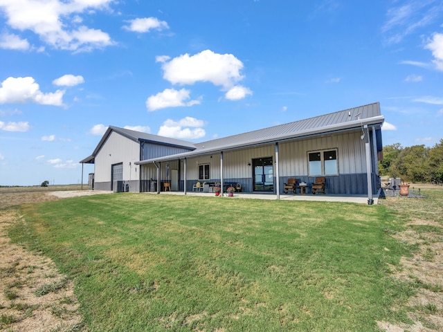 rear view of property with a yard