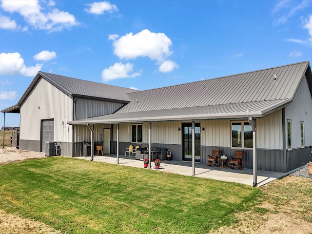 rear view of house with a patio area, a yard, and central AC