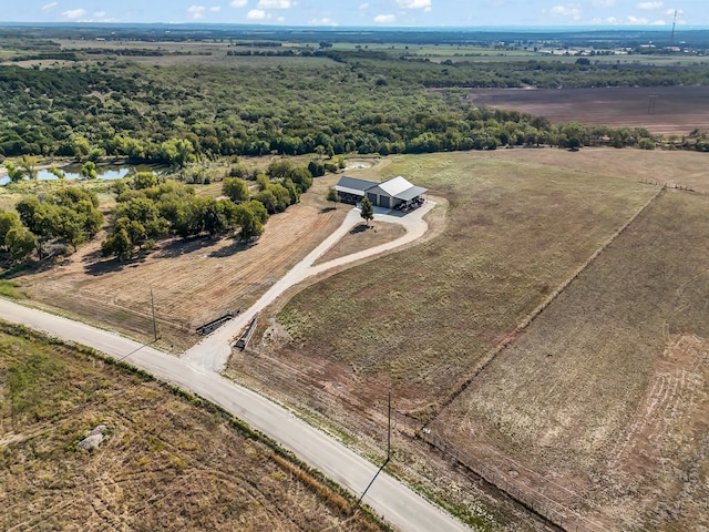 birds eye view of property with a rural view and a water view