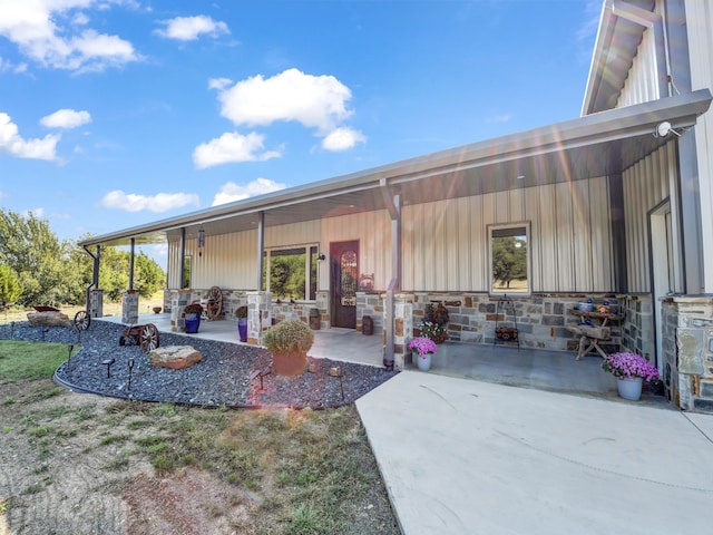 back of property featuring covered porch