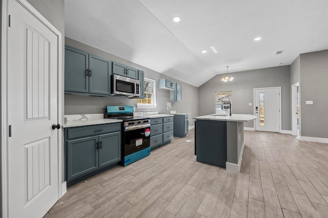 kitchen featuring stainless steel appliances, lofted ceiling, light countertops, a sink, and light wood-type flooring