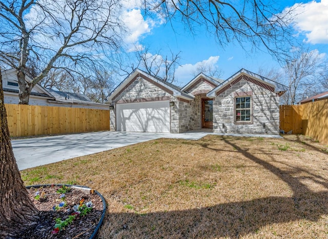 view of front of home with concrete driveway, an attached garage, fence, stone siding, and a front lawn