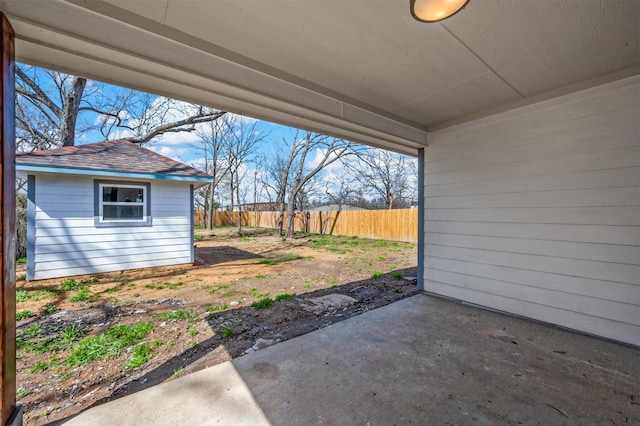 view of yard with a patio area, fence, and an outdoor structure