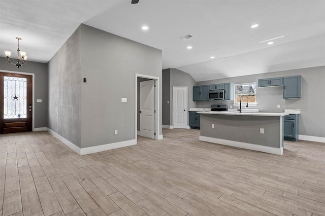 kitchen with a chandelier, visible vents, light countertops, appliances with stainless steel finishes, and light wood finished floors