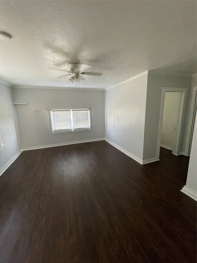 empty room featuring ceiling fan, a textured ceiling, dark hardwood / wood-style flooring, and ornamental molding