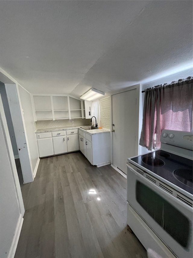 kitchen with white cabinets, a textured ceiling, white electric range oven, light hardwood / wood-style flooring, and sink