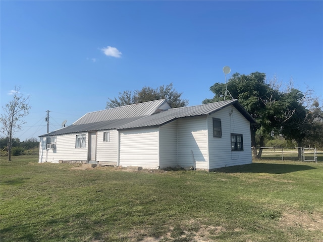 view of property exterior with a lawn