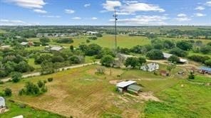 birds eye view of property with a rural view