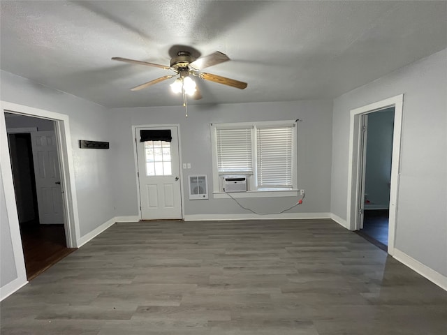 foyer entrance featuring hardwood / wood-style flooring, cooling unit, heating unit, a textured ceiling, and ceiling fan