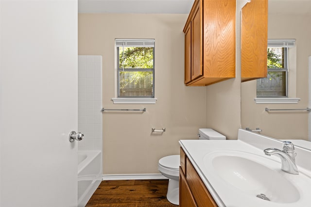 full bathroom featuring vanity, hardwood / wood-style floors, toilet, and a healthy amount of sunlight