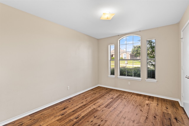 unfurnished room with hardwood / wood-style floors