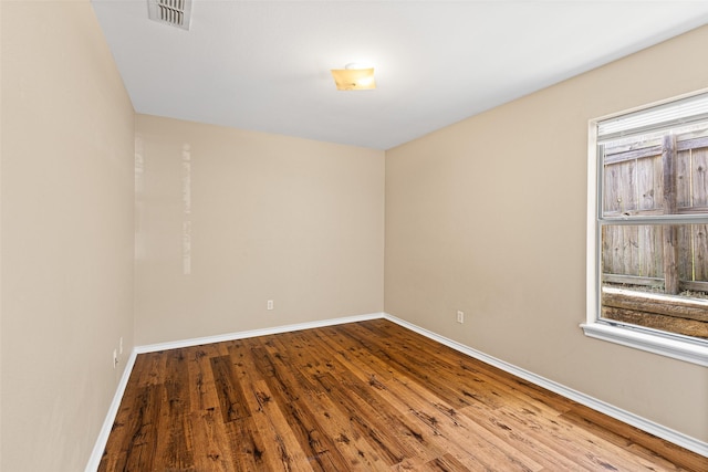 1108 E E Park, Lindale, TX 75771 - spare room featuring wood finished floors, baseboards, and healthy amount of natural light
