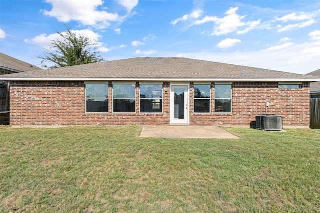 rear view of house with a yard, a patio area, and central air condition unit