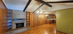 149 NW Suzanne Ter, Burleson, TX 76028 - unfurnished living room featuring ceiling fan, wood finished floors, and a fireplace
