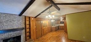 149 NW Suzanne Ter, Burleson, TX 76028 - unfurnished living room with wood finished floors, a ceiling fan, and a large fireplace
