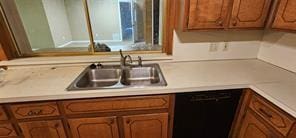 149 NW Suzanne Ter, Burleson, TX 76028 - kitchen with black dishwasher, a sink, light countertops, and brown cabinets