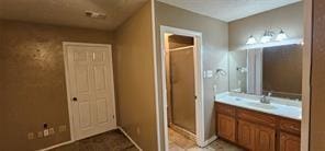 149 NW Suzanne Ter, Burleson, TX 76028 - bathroom featuring a stall shower and vanity