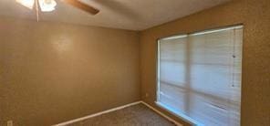 149 NW Suzanne Ter, Burleson, TX 76028 - carpeted spare room featuring a ceiling fan and baseboards