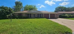 ranch-style home featuring a front lawn and a garage