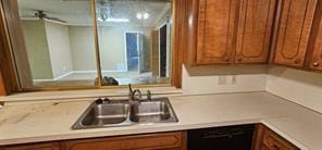 149 NW Suzanne Ter, Burleson, TX 76028 - kitchen featuring a sink, brown cabinetry, black dishwasher, and light countertops