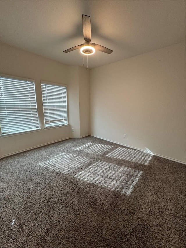 empty room featuring carpet floors and ceiling fan