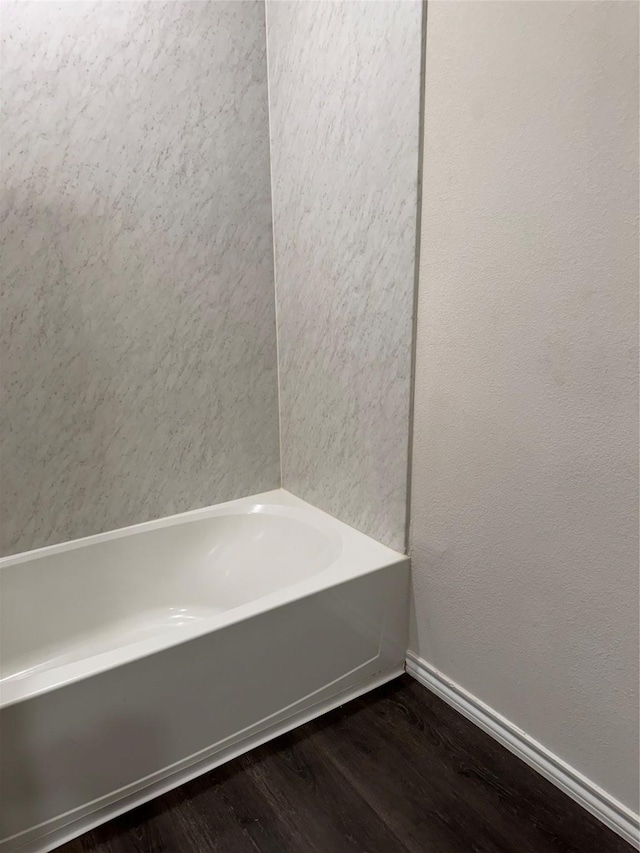 bathroom featuring a tub and wood-type flooring