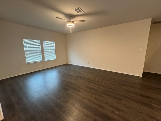 unfurnished room with ceiling fan and dark hardwood / wood-style flooring