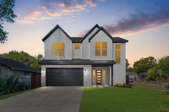 modern farmhouse style home with a garage and a yard