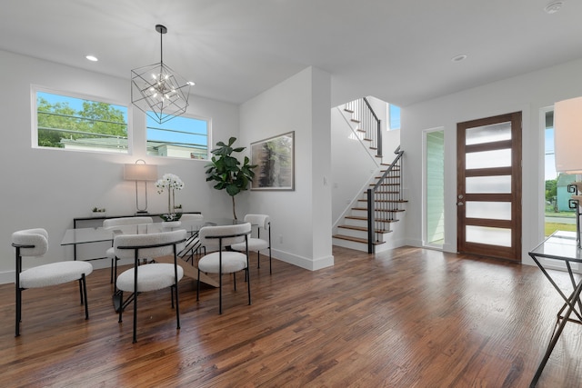 dining room featuring dark wood-type flooring and an inviting chandelier