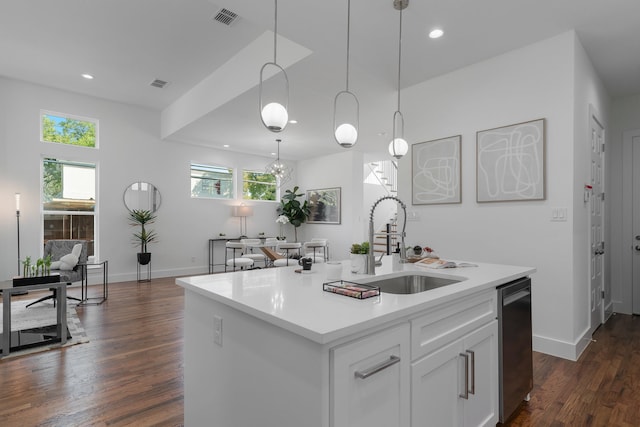 kitchen with an island with sink, dark hardwood / wood-style flooring, a wealth of natural light, and white cabinetry