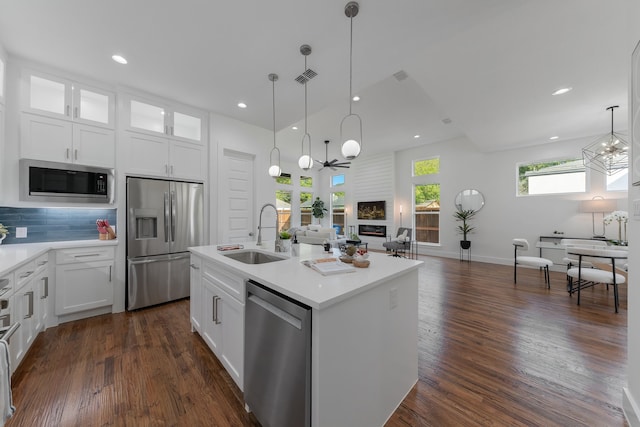 kitchen with white cabinets, an island with sink, appliances with stainless steel finishes, and sink