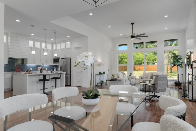 living room with dark hardwood / wood-style flooring and ceiling fan