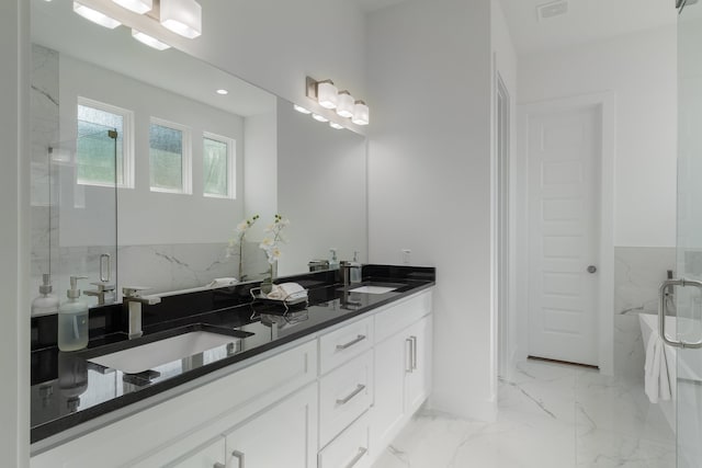 bathroom featuring vanity and separate shower and tub