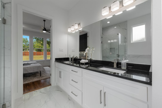 bathroom featuring ceiling fan, vanity, an enclosed shower, and a healthy amount of sunlight