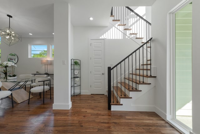 foyer entrance featuring a chandelier and dark hardwood / wood-style floors