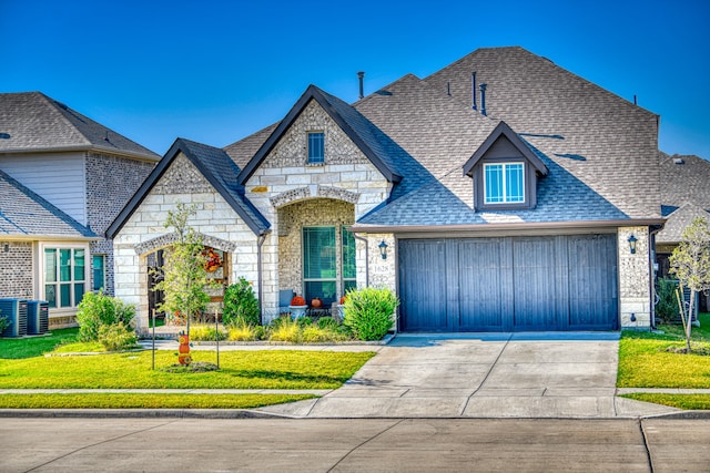 view of front of home featuring a garage and a front lawn