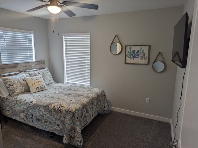 carpeted bedroom featuring multiple windows and ceiling fan