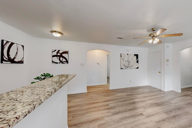 living room with light hardwood / wood-style floors and ceiling fan