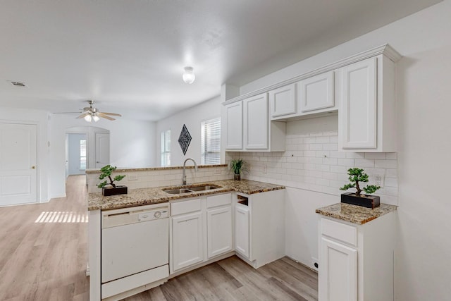 kitchen featuring white cabinets, sink, light wood-type flooring, and dishwasher