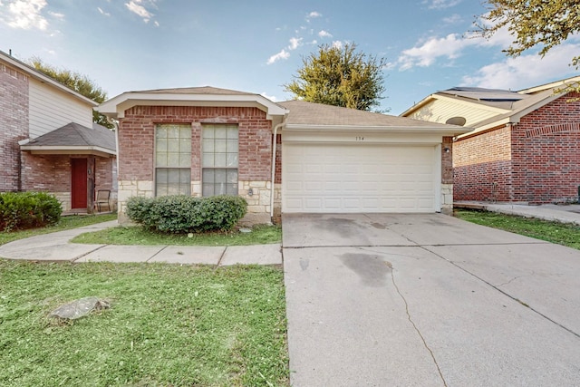 view of front of property with a garage and a front yard