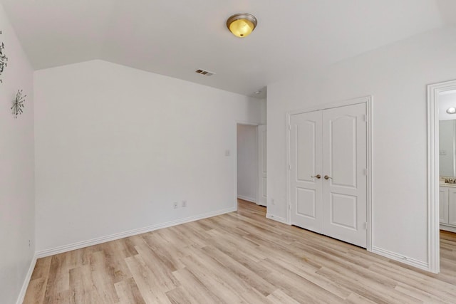 unfurnished bedroom with a closet and light hardwood / wood-style flooring