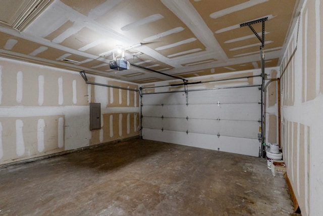 garage featuring a garage door opener and electric panel