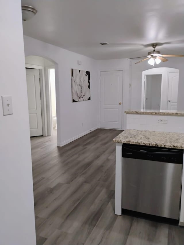 kitchen with dishwasher, dark hardwood / wood-style flooring, ceiling fan, and light stone countertops