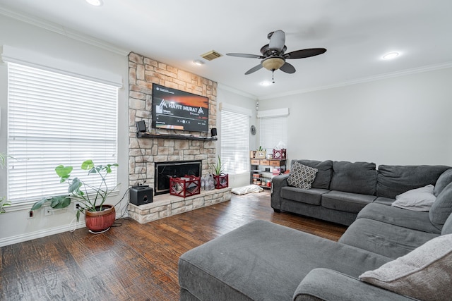 living room featuring ceiling fan, a fireplace, ornamental molding, and dark hardwood / wood-style floors