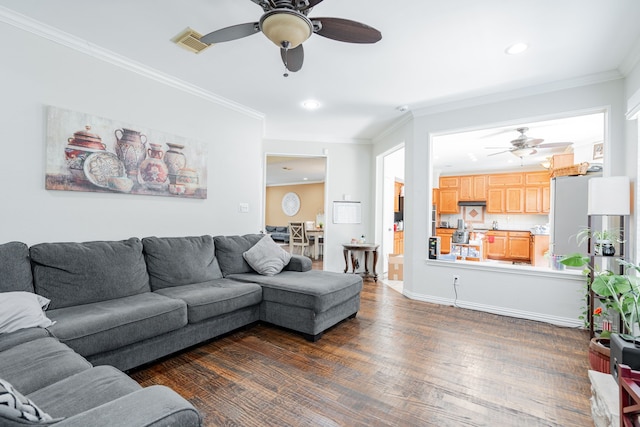 living room with ceiling fan, ornamental molding, and dark hardwood / wood-style floors