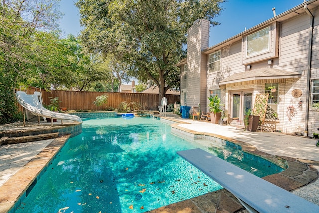 view of pool featuring a patio area and a water slide