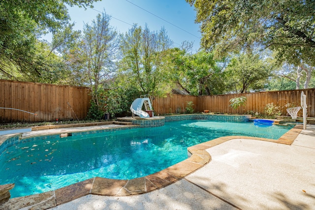 view of pool with a patio and a water slide